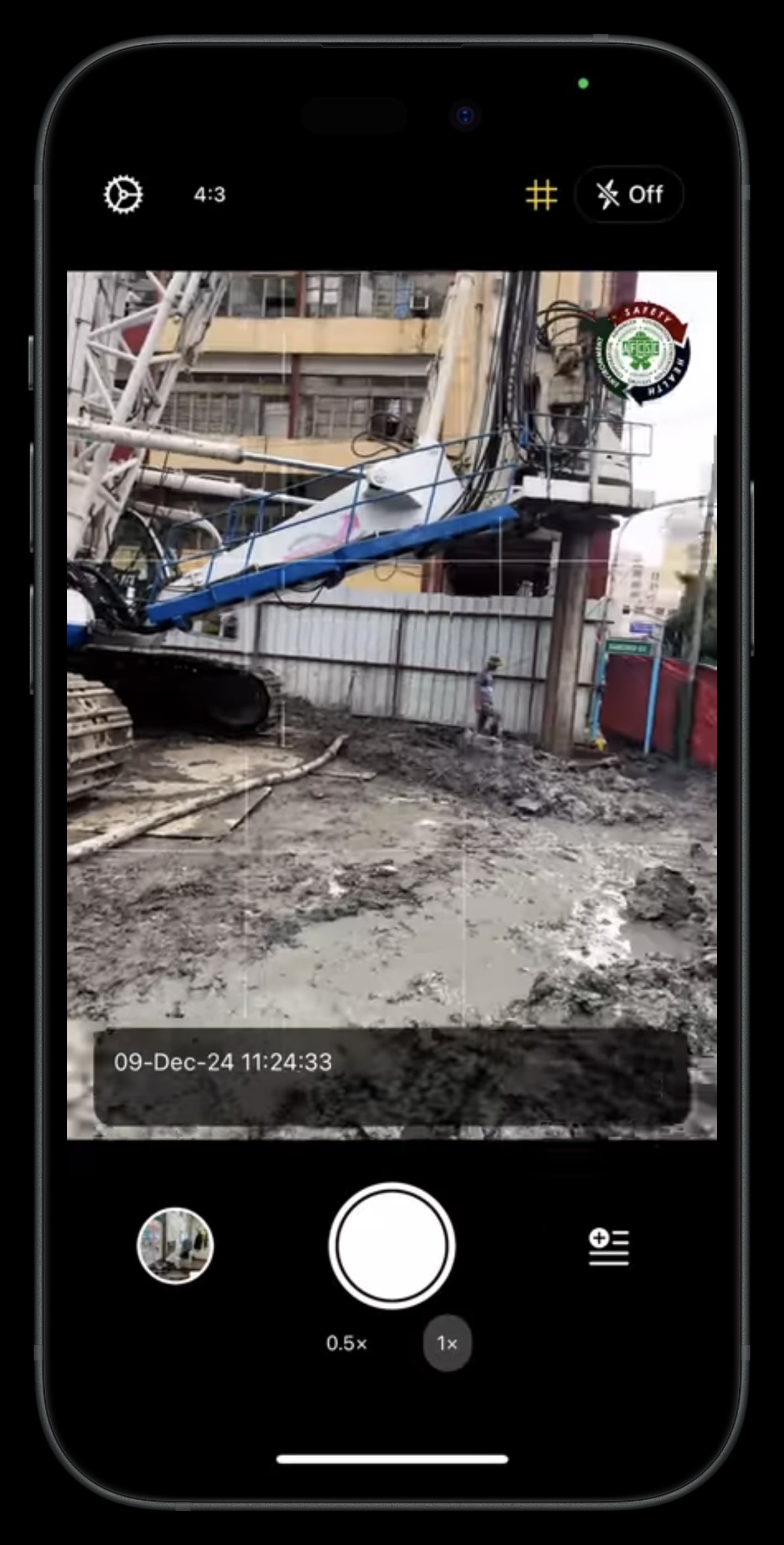 Lens camera on a construction site with timestamp and project overlay on the viewfinder